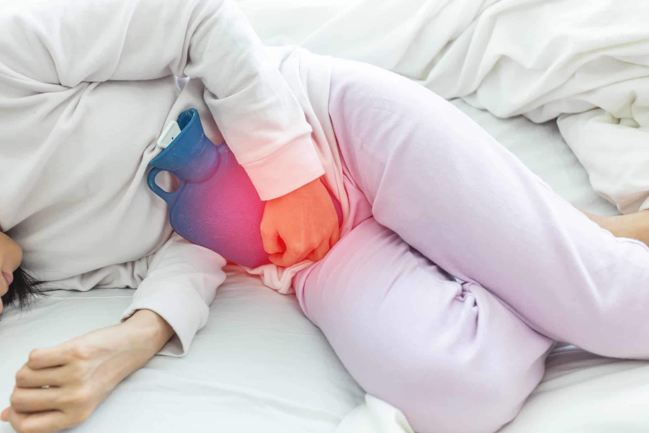 Woman have bladder pain sitting on bed in bedroom after wake up feeling so sick and painful,Healthcare concept