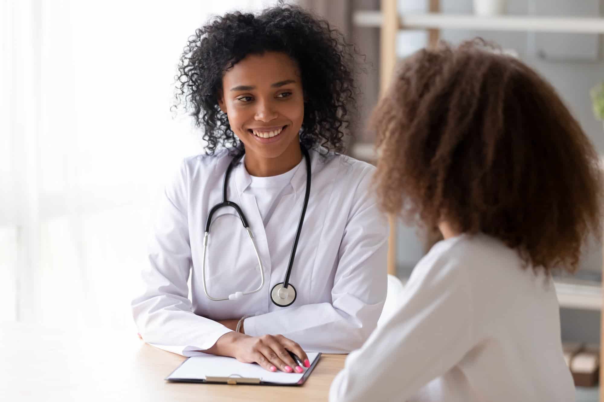A young woman sharing her OBGYN checklist with her own OBGYN