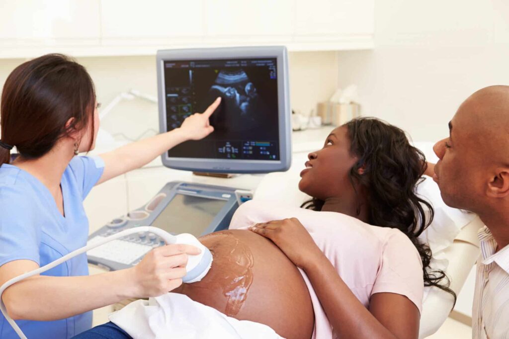 happy black couple getting an ultrasounds to see the gender of their baby