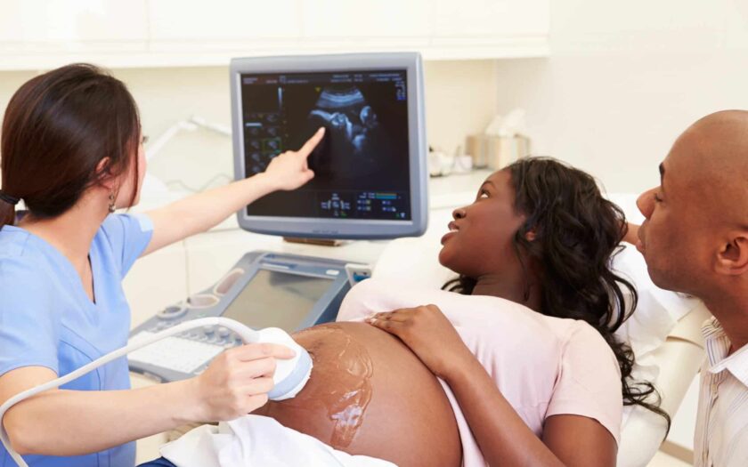 happy black couple getting an ultrasounds to see the gender of their baby