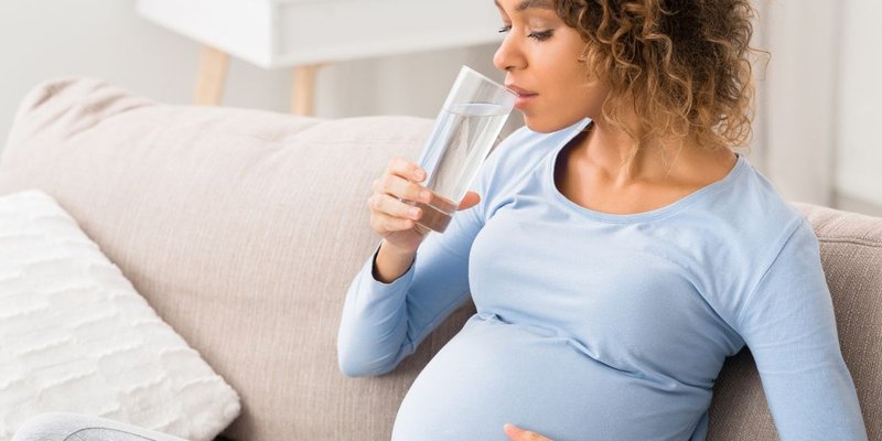 pregnant woman drinking water