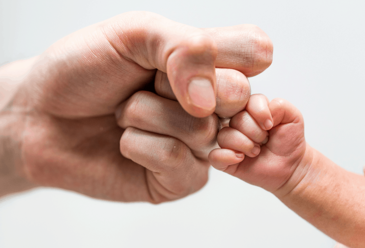 dad and baby fist bumping